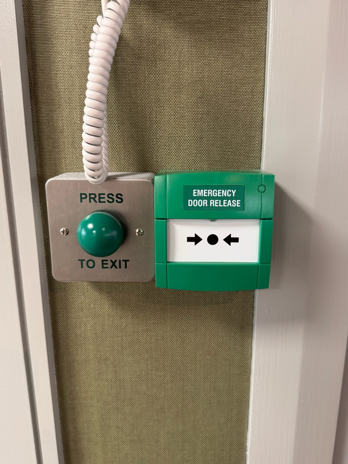 Emergency door release and press-to-exit button on an escape door
