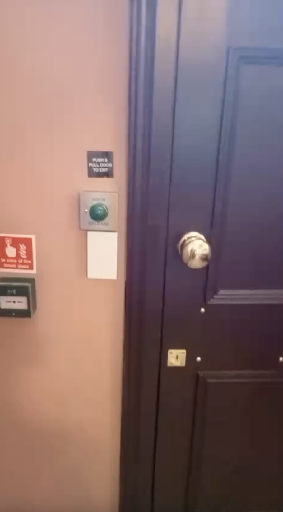Communal corridor with fire door, green door release and 'in case of fire break glass' call point
