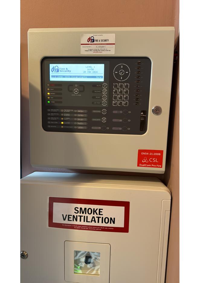 Fire alarm panel, smoke vent control and emergency exit signage in a commercial building