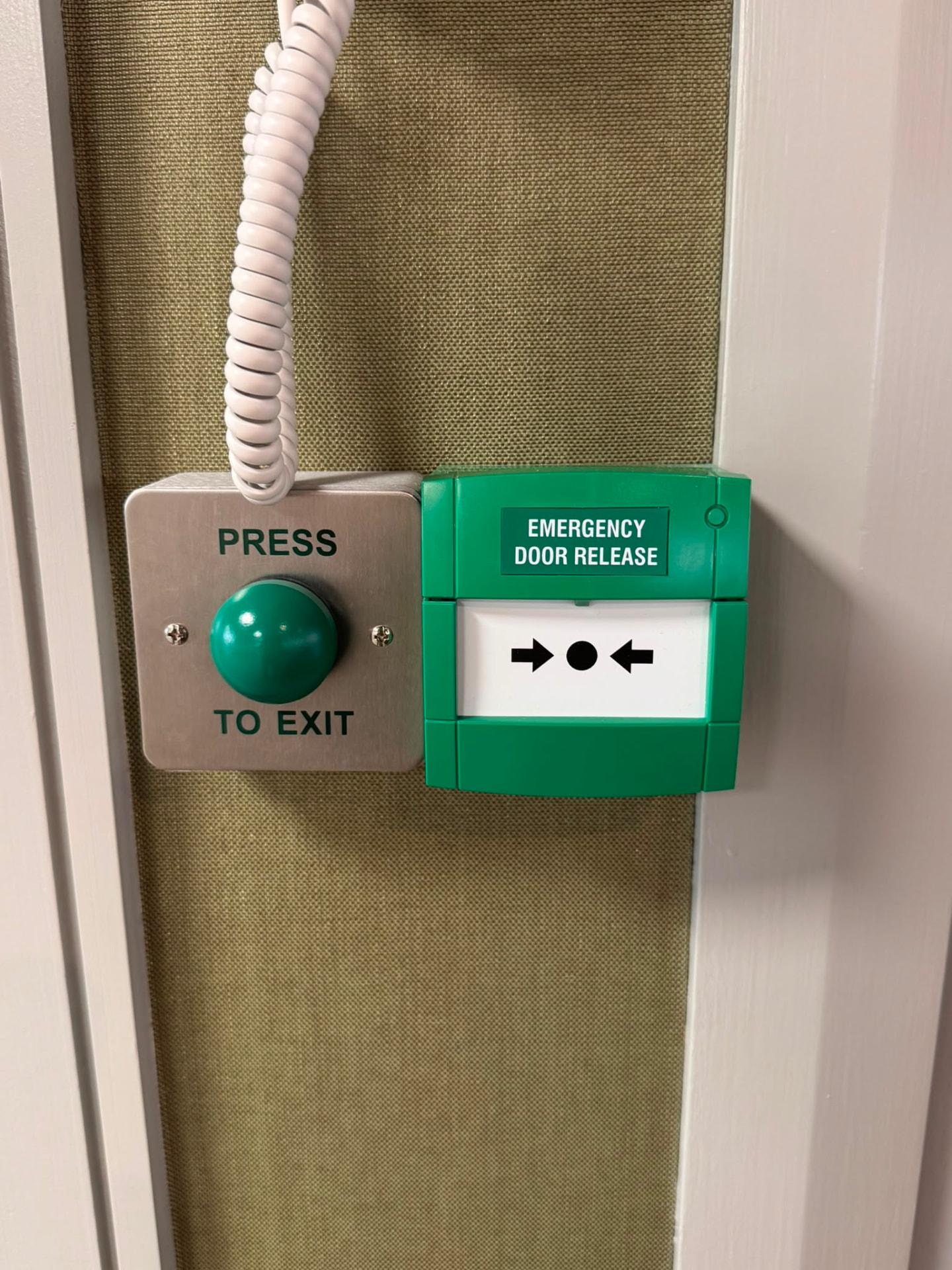 Emergency door release and press-to-exit button on a final exit door in a licensed venue