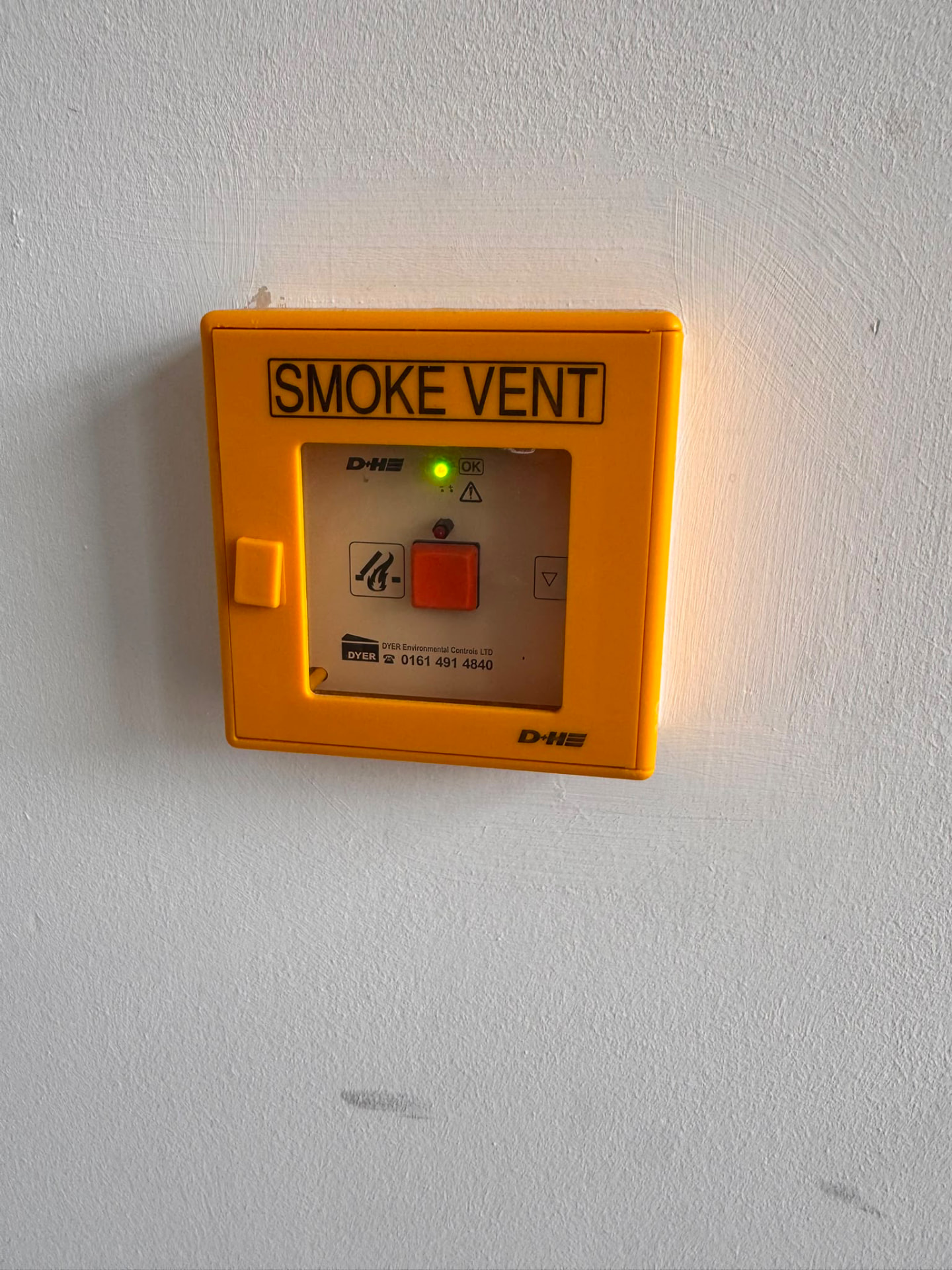 Smoke vent control point on a stairwell wall in a public assembly building