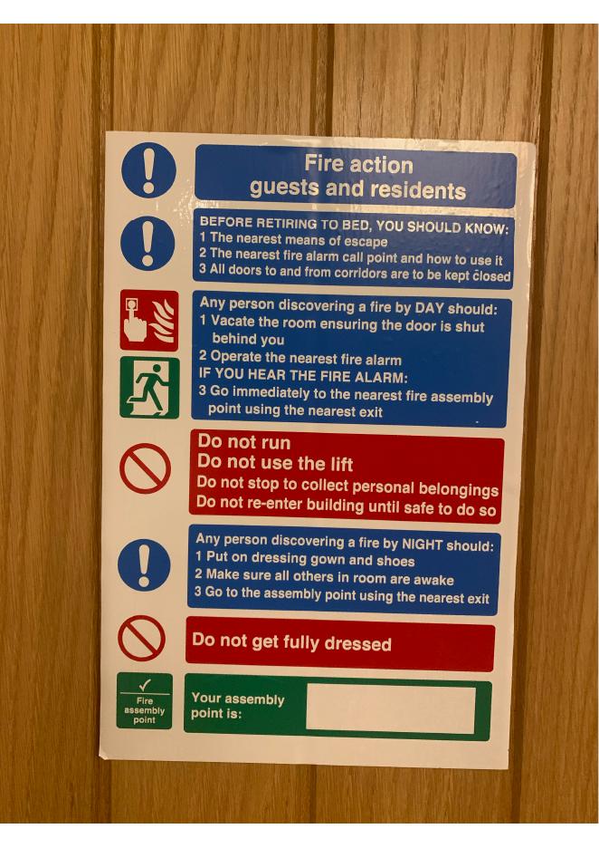 Fire action notice for guests and residents fixed to a guest room door