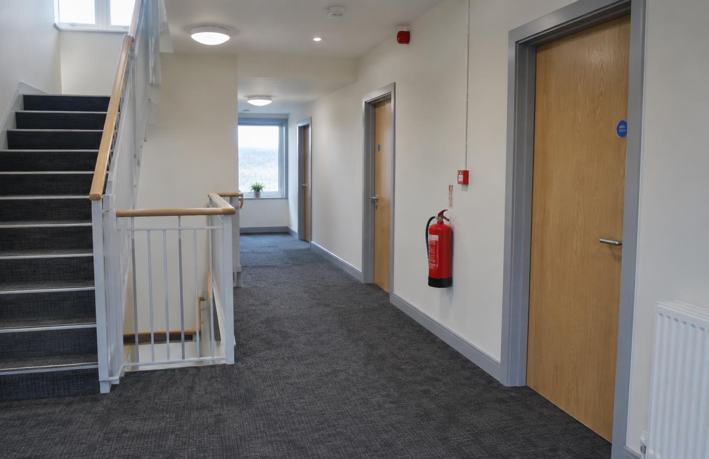 Anonymous short-term-let living area with illuminated exit signage